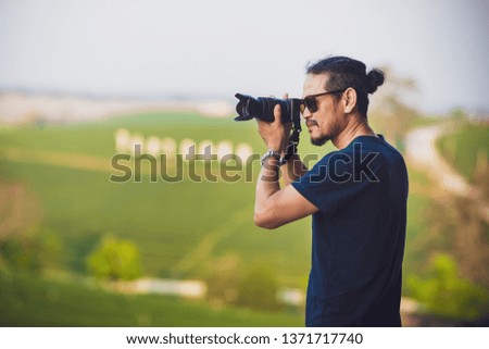 photographer taking photo of mountain landscape
