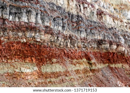 the texture of different layers of clay underground in a clay quarry after geological study of the soil.
