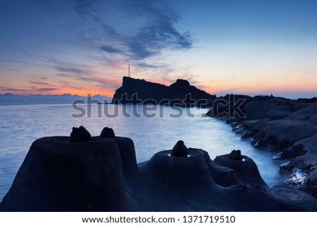 Rocky geological coast landscape in the early morning sunrise.