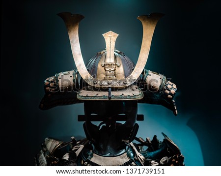 Japanese warrior armor, closed up to helmet part, which was originally worn by Samurai. Shot on dark background.  Royalty-Free Stock Photo #1371739151