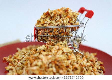 Close-up of dried shrimp on a shopping car about online dried seafood trading business  White background