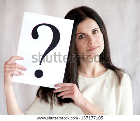Question mark in hands of the business woman, a studio photo