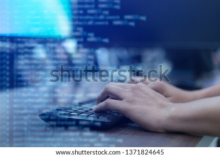 employee programmer man hand type on keyboard at computer desktop for input configuration  language to software to fix bug or defect system in operation office room for develop of technology concept Royalty-Free Stock Photo #1371824645