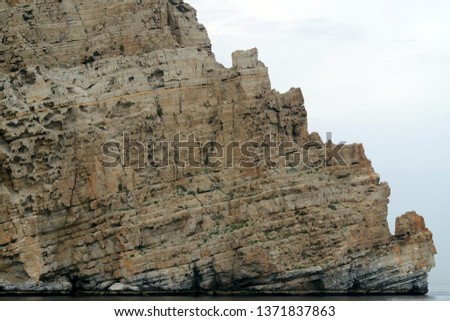 Picture of colored rocky mountains, cliffs along the coast. Beautiful background.