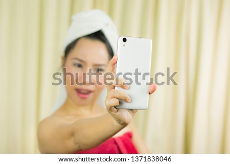 woman acting playing on phone. she wear a skirt to cover her breast after wash hair, Wrapped in Towels After Shower 