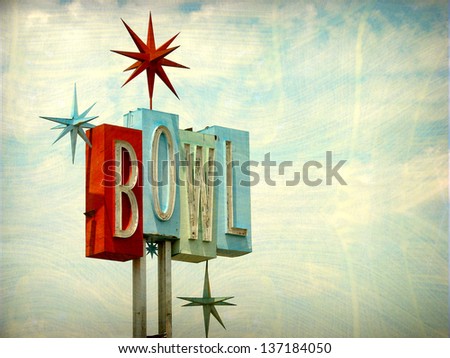   aged and worn vintage photo of neon bowl sign