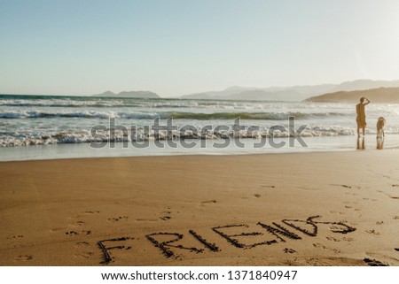 Handwriting Friends on Sand Summer Background. Happy Dog and Girl Symbol on Holiday Tropic Island Scene. Shape on Ocean Coast with Seascape and Sunlight. Object on Beach Landscape Waves
