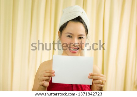 asian woman holding empty blank banner and acting. she wear a skirt to cover her breast after wash hair, Wrapped in Towels After Shower 