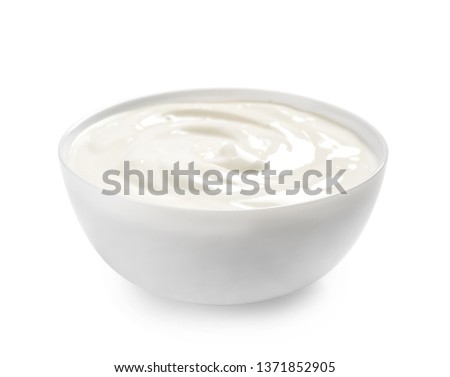 Bowl with creamy yogurt on white background