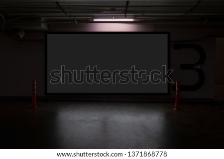 indoor car parking and empty black billboard .Blank space for text and images.
