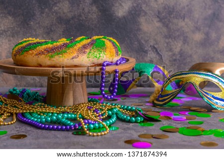 Festive cake for Mardi Gras (Fat Tuesday) holiday with decor on grey table