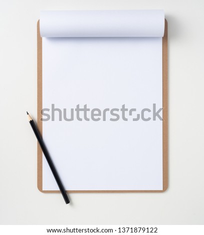 Design concept - top view of A4 white paper on brown clipboard isolated on white background for mockup. real photo, not 3D render