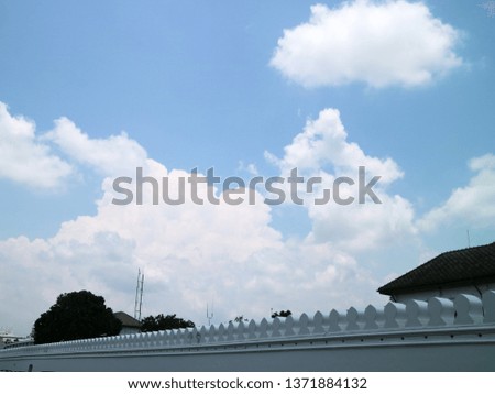 White walls, blue background and white clouds