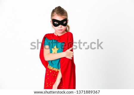 blond girl with black mask and red cape posing in front of white background
