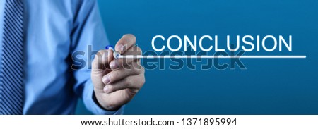 Man writing Conclusion text in screen. Royalty-Free Stock Photo #1371895994