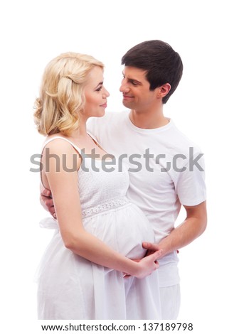 Young attractive couple: pregnant mother and happy father isolated on white