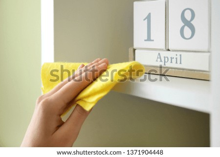 Woman cleaning furniture in room