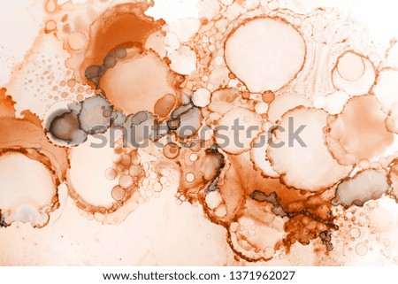 Orange alcohol ink texture with abstract washes and paint stains on the white paper background.