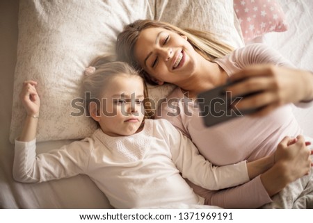 Mom, I'm tired of this. Mother daughter in bed.