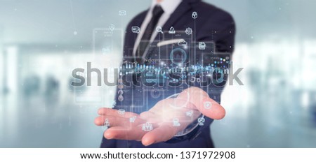 View of Businessman holding User interface screens with icon, stats and data 3d rendering