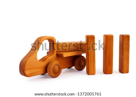 Photo of a wooden car truck loaded with small wooden rectangles made of beech on a white isolated background