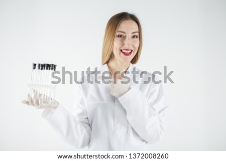 Young scientist holding a test tubes in laboratory. Laboratory, Scientist, Women.