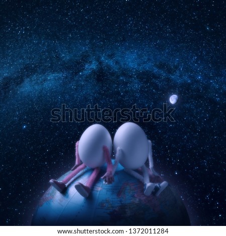 Couple of egg humans sitting on a Earth planet in outer space under the starry sky.