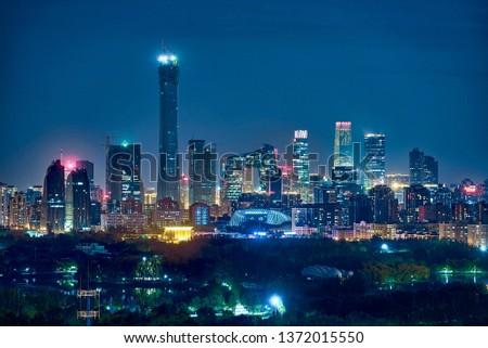 City skyline of Beijing/Night view/CBD behind a park