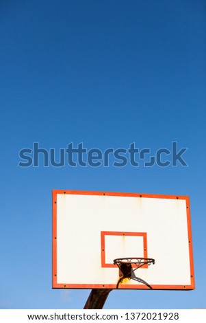 basketball board with basket hoop against blue sky. Sport, recreation.