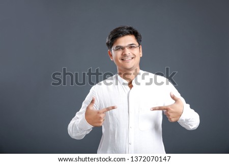 Indian young man showing direction with hand