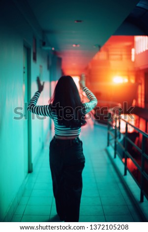 Women wearing black and white stripes shirts Is moving With reflections from windows and light leak blur photo