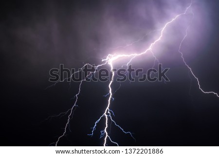 Lightning bolt in night sky Royalty-Free Stock Photo #1372201886