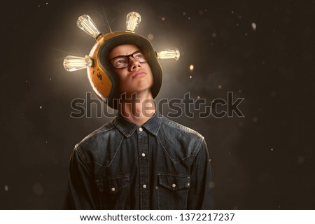 Smart teenager wears a lightbulb helmet Royalty-Free Stock Photo #1372217237