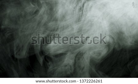 Close up for thick white smoke spreading over black background. Stock footage. Dense fog flying isolated in the dark.