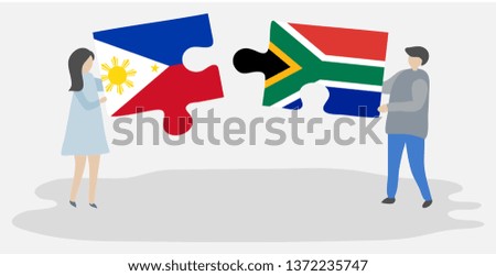 Couple holding two puzzles pieces with Filipino and South African flags. Philippines and South Africa national symbols together.