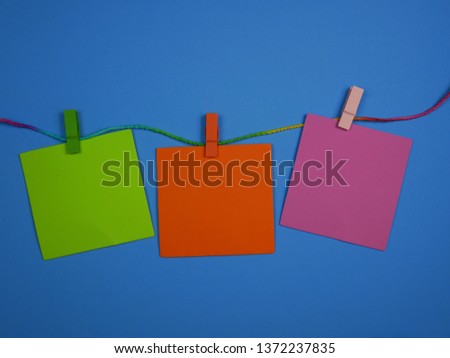 The blank label, green, orange, pink hanging on the rope For making cards