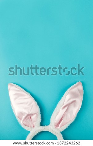 Easter decoration bunny ears on a blue background. Festive background with decor.