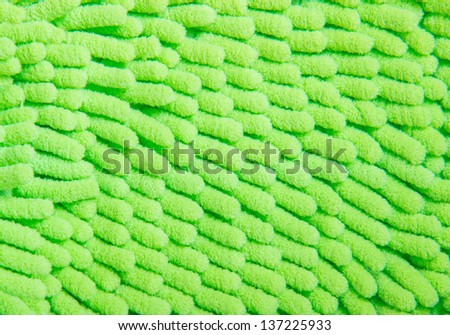 A green carpet texture, close-up