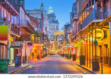Bourbon St, New Orleans, Louisiana, USA cityscape of bars and restaurants at twilight. Royalty-Free Stock Photo #1372299326