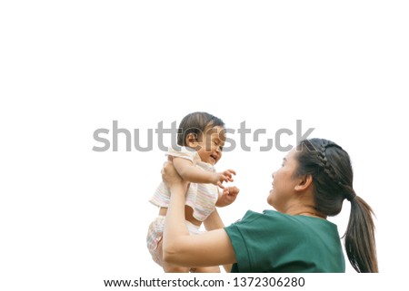 Mother lifting and playing with newborn baby, baby talking to mother. Health care family love together mother concept
