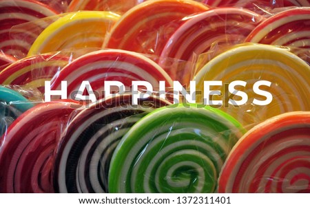 A picture of word happiness with lots of lollipop.