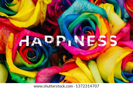 A picture of word happiness with colorful painted roses.