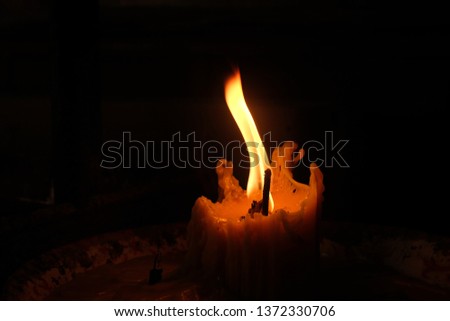 Candle light in dark room.