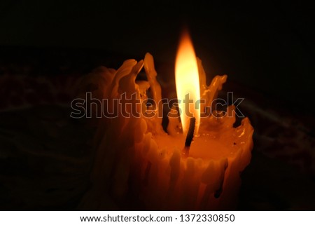 Candle light in dark room.