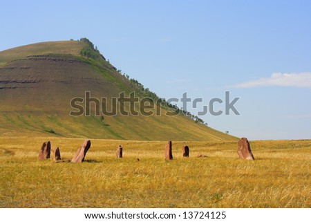 Ancient monuments of Khakassia on the hill background. Variant two. Royalty-Free Stock Photo #13724125