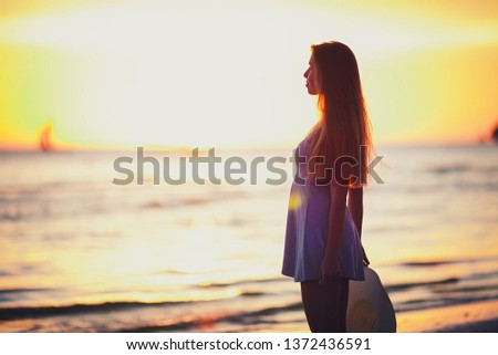 Summer exotic vacation Maldive holiday background - happy young pretty Caucasian girl take sunbath smiling and relaxing on sand tropical beach with palms with warm weather on holiday play with hat