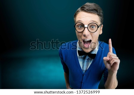 Young nerd man posing on background