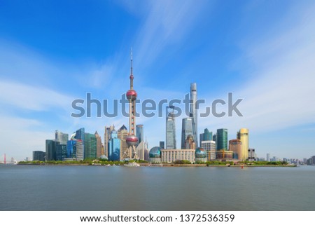 The Pearl at Shanghai Downtown skyline by Huangpu River, China. Financial district and business centers in smart city in Asia. Skyscraper and high-rise buildings near The Bund at noon.
