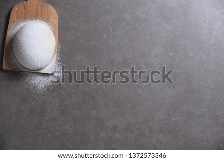
Dough and Flour on Stone Background