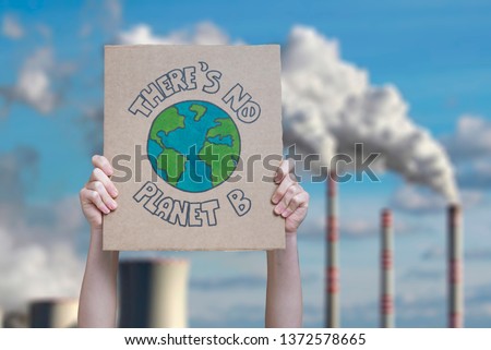 Climate change manifestation poster on an industrial fossil fuel burning  Royalty-Free Stock Photo #1372578665